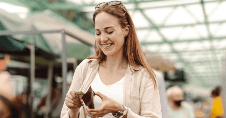 young millennial woman checking her wallet