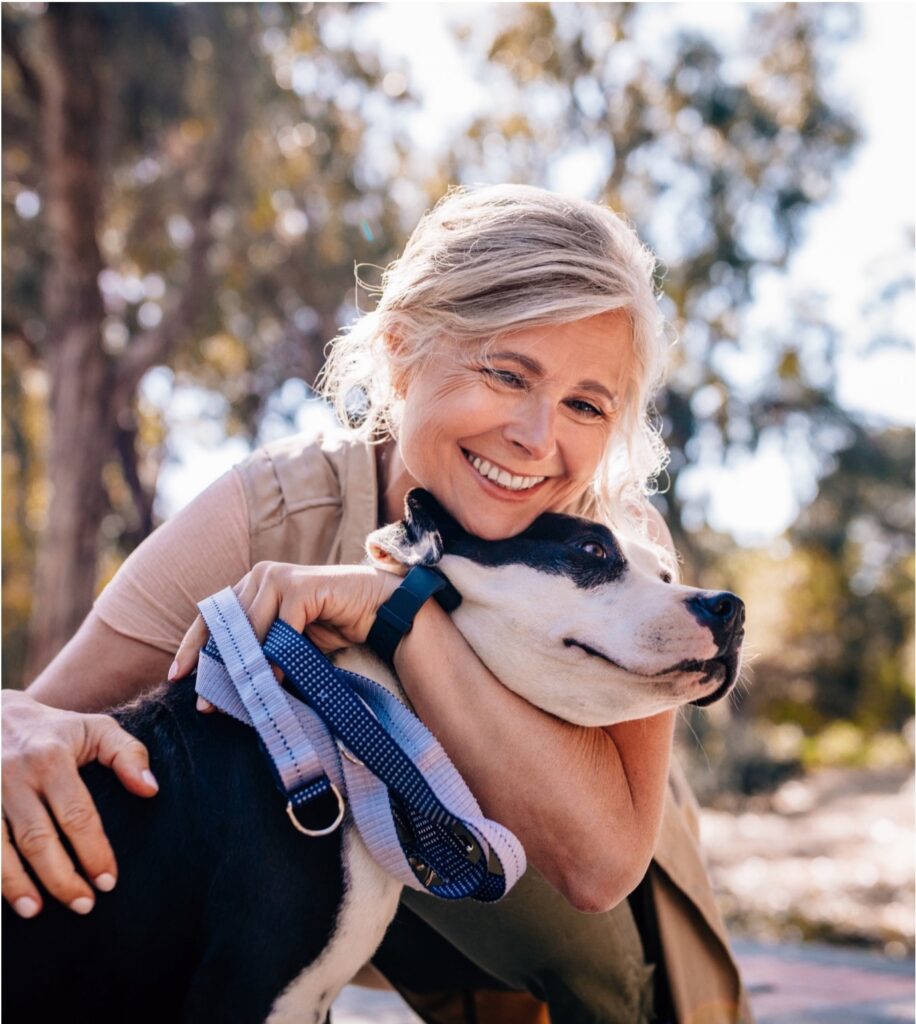 woman clutching dog 