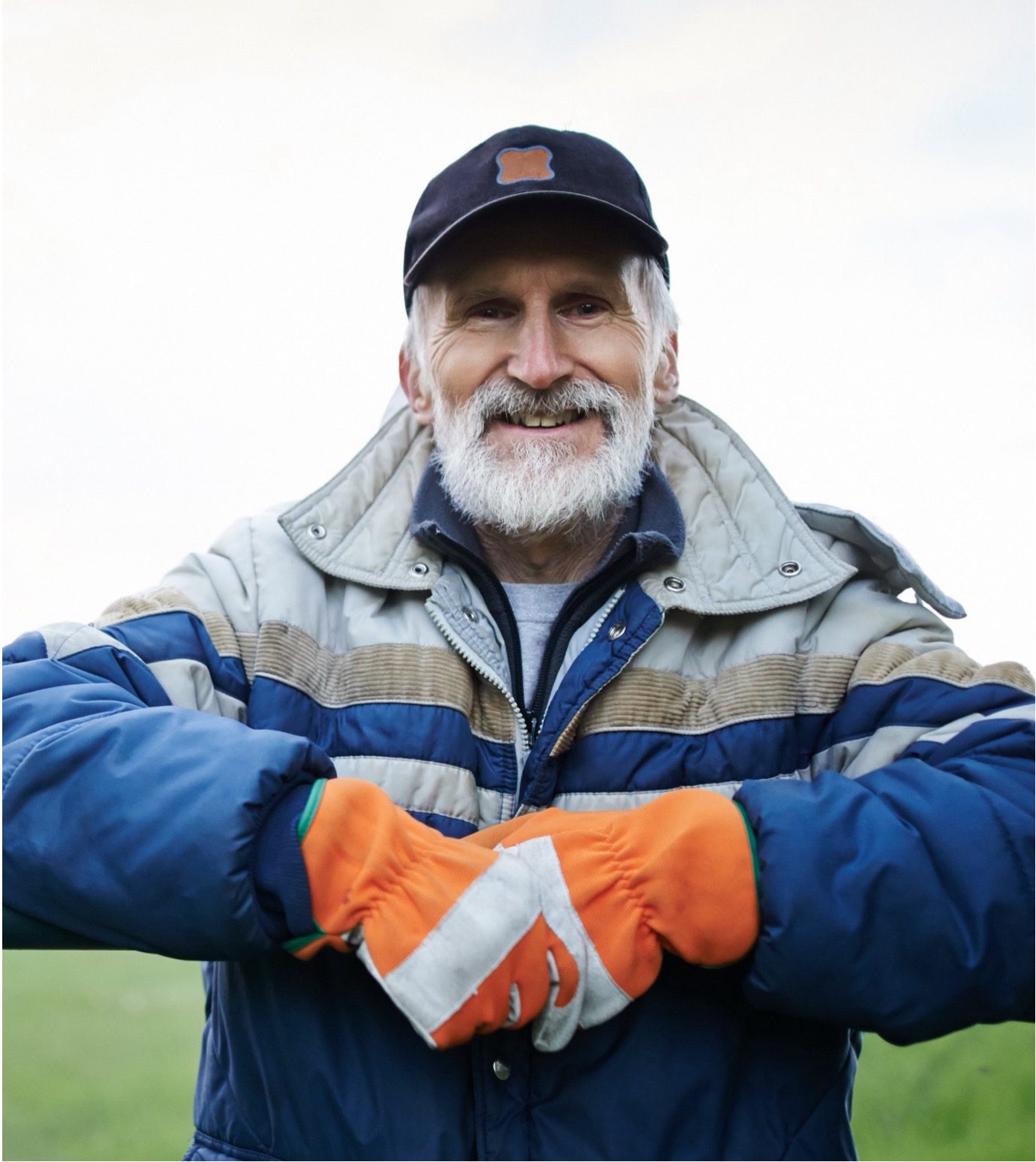 farmer leaning on fence