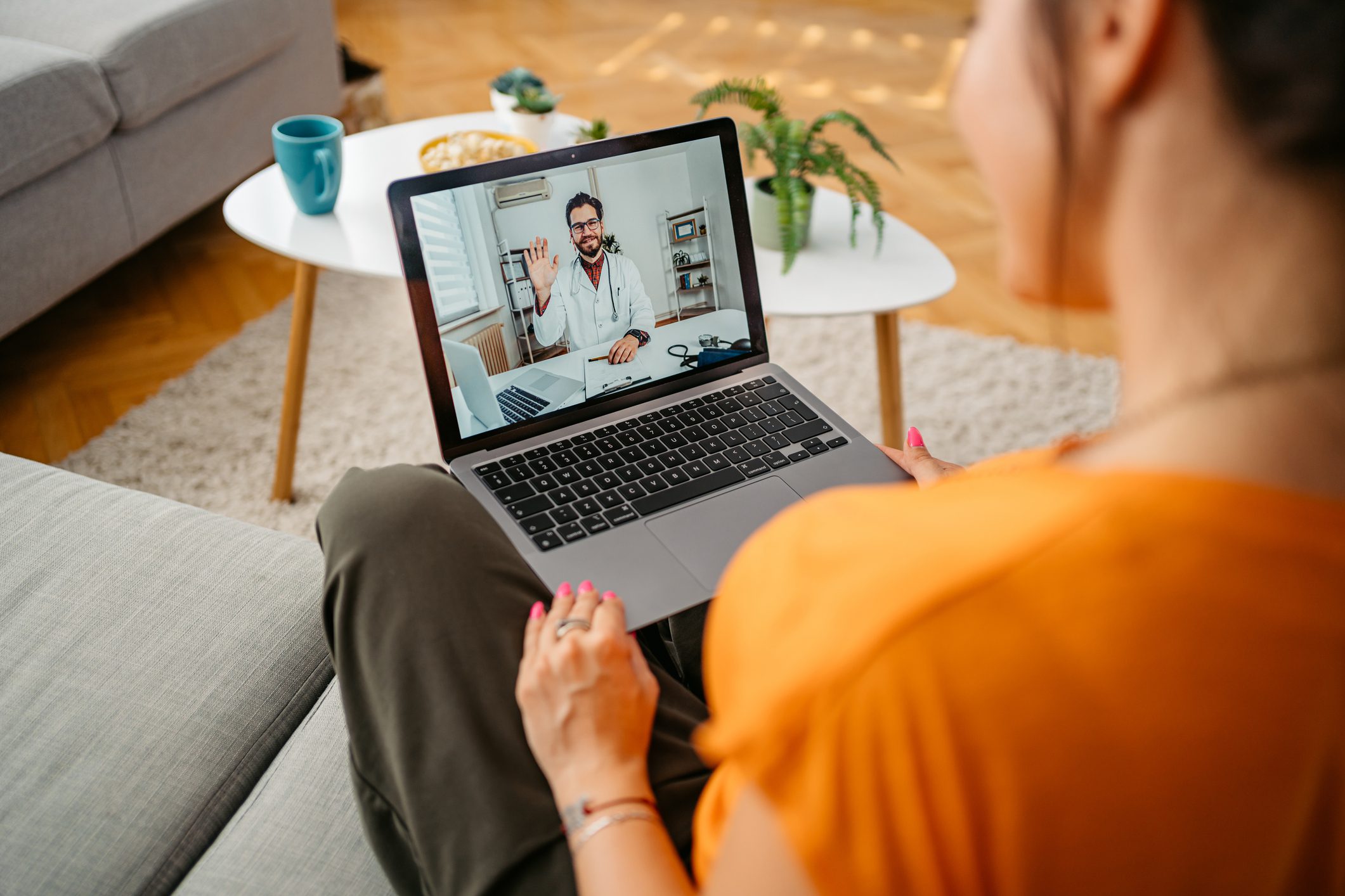 Young Woman Having A Doctor's Appointment Online At Home