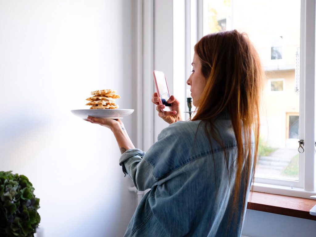 women taking picture of food