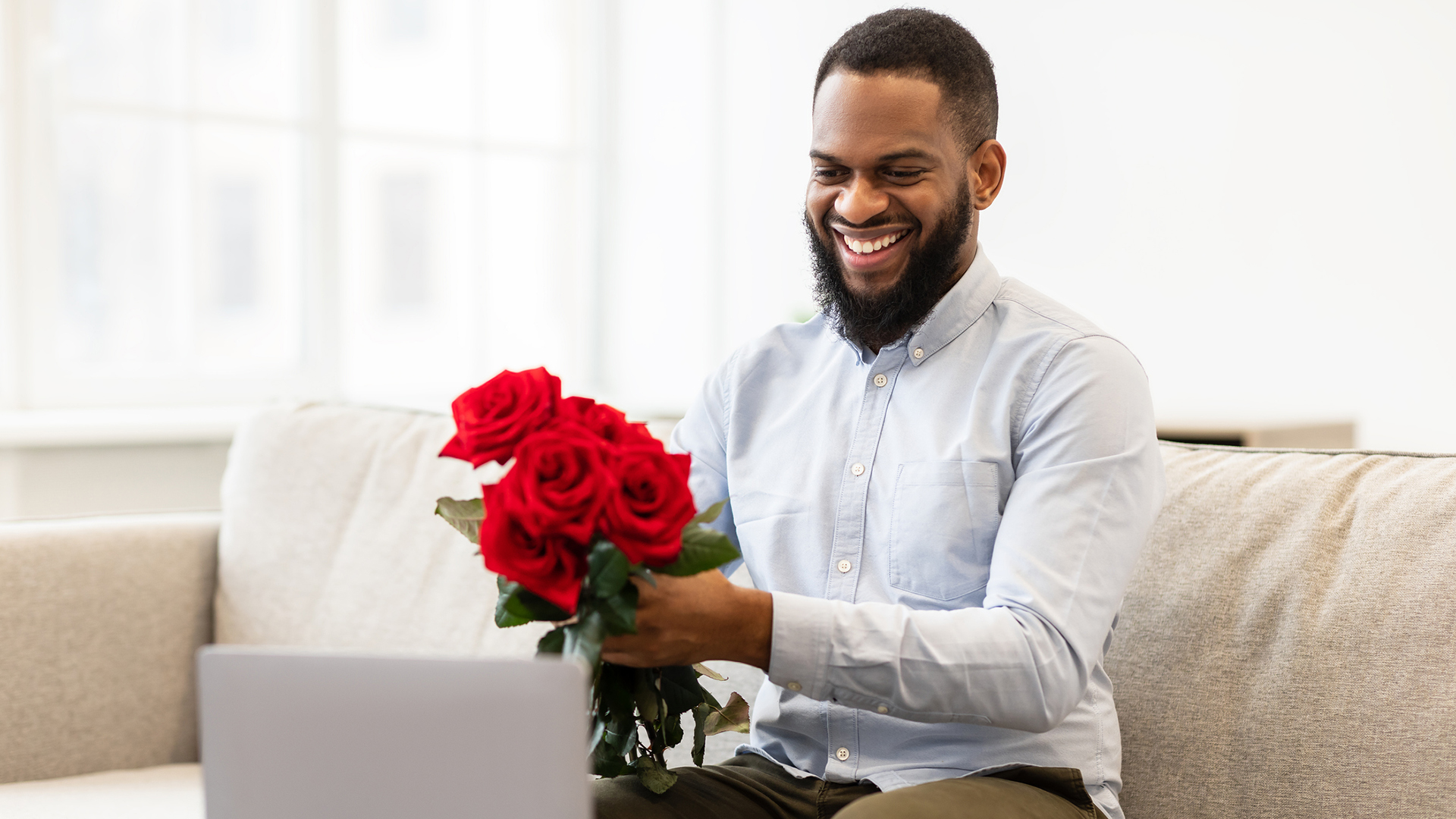man receiving flowers and watching video message