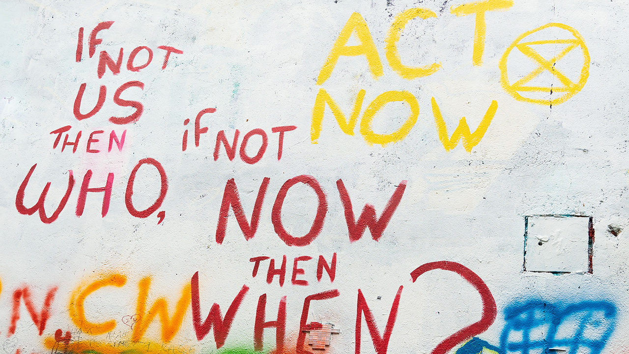 graffiti on wall encouraging people to act