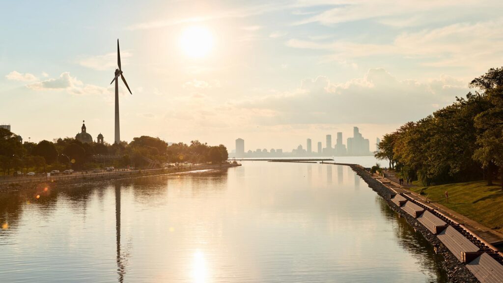 waterway with windmill on the outskirts of a city