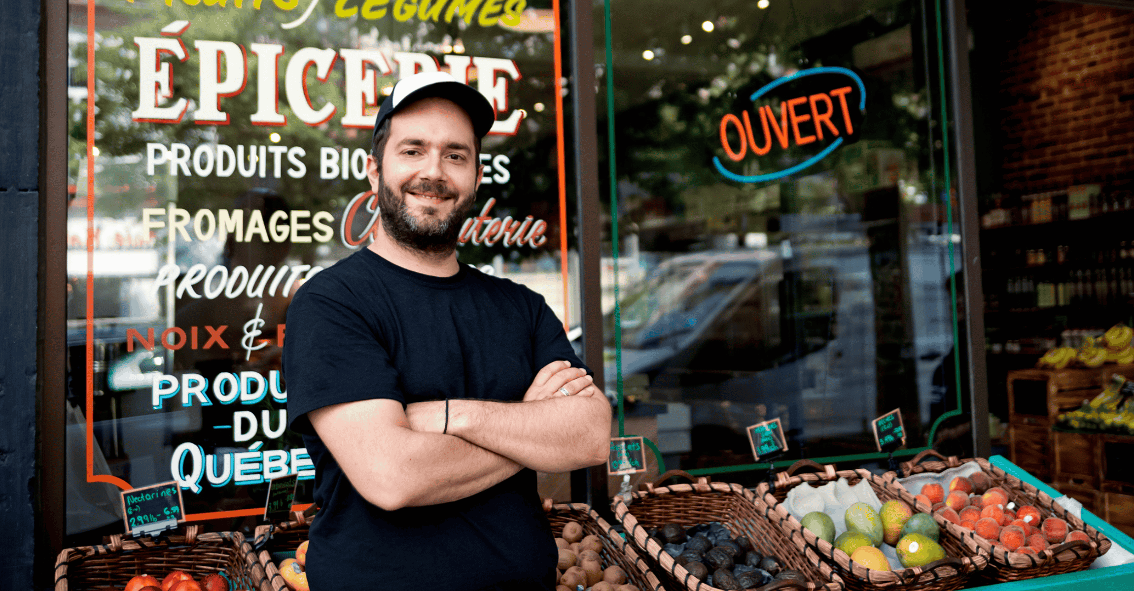 Zero waste oriented small local fruit and grocery store. Family business. Fruits and vegetables are organic and sold without wrapping. Unsold items are use to make juices, smoothies and take-out healthy food. Here the owner, posing for a portrait. Horizontal waist up outdoors shot.