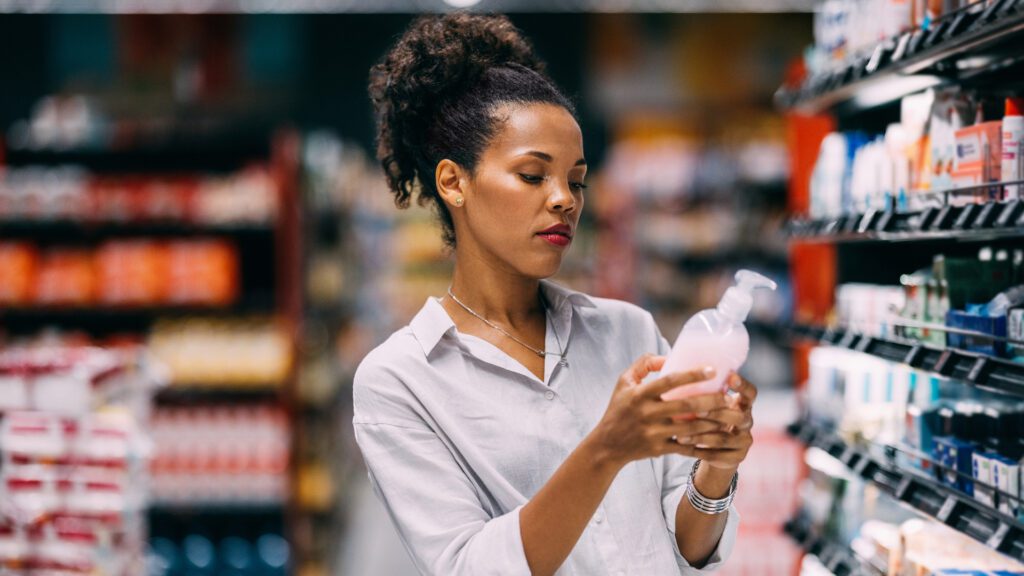 woman looking at product in grocery store