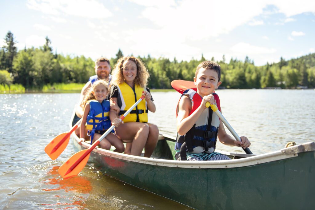 Travelling family in a Canoe on a lake having fun in Canada.