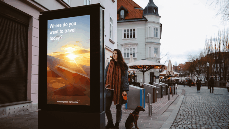 Woman in her late 30s looking at the electronic smart sign in the city centre, browsing the tourist locations offers thinking of traveling again after the pandemic.