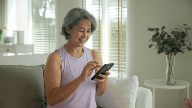 Women sitting on a couch scrolling on her phone