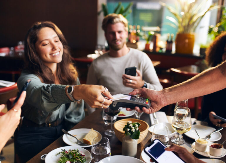 Woman paying for dinner with card
