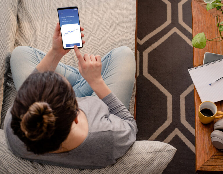 person investing on phone
