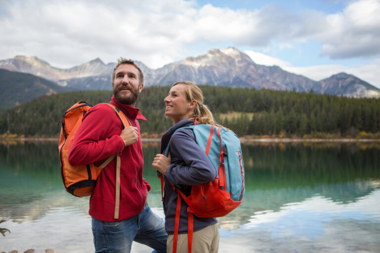Man and woman hiking by lake